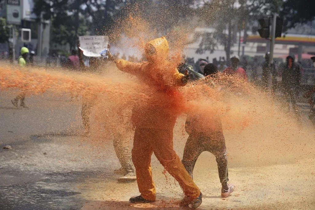 protestors scatter as kenyan police spray a water canon on them ap photobrian inganga